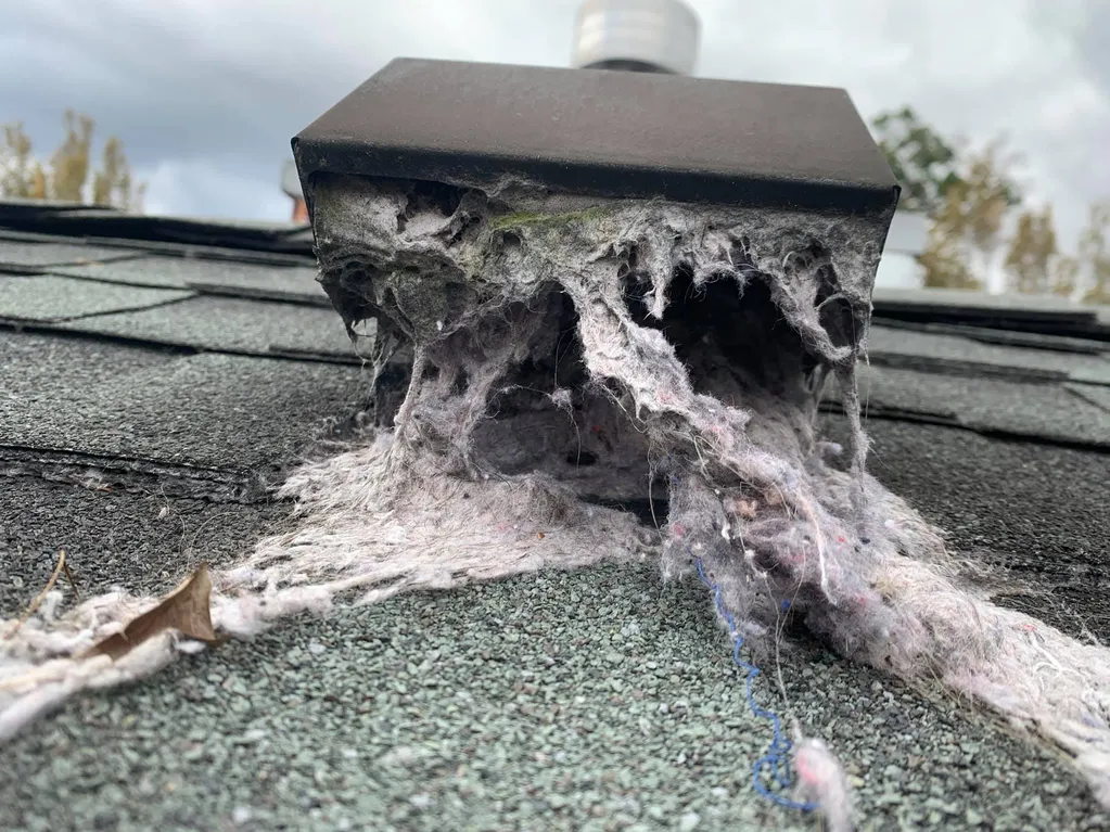 a very clogged and dirty dryer vent on the roof of a home in broomfield colorado